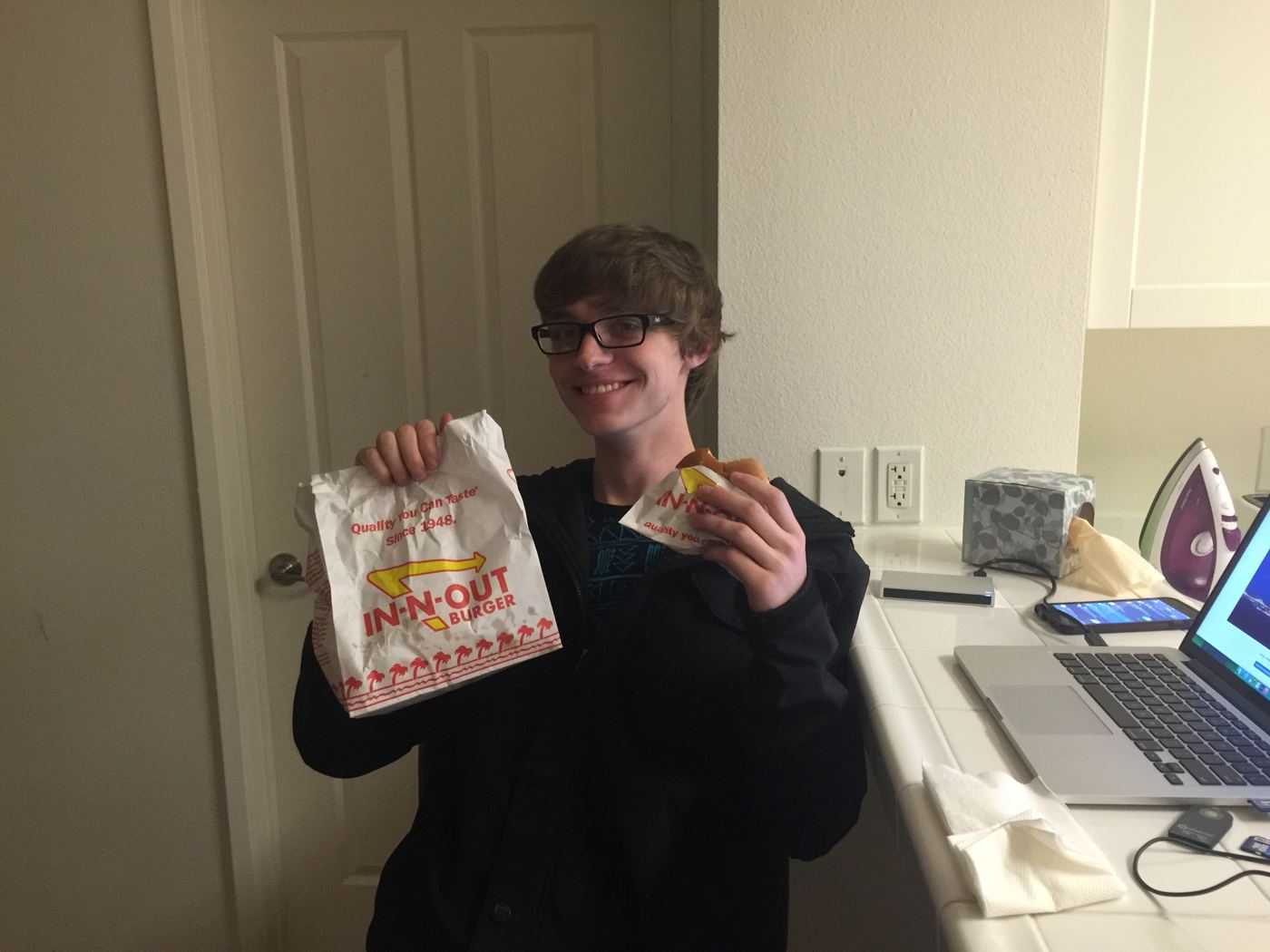 Cameron holding up an In-N-Out bag, 2015