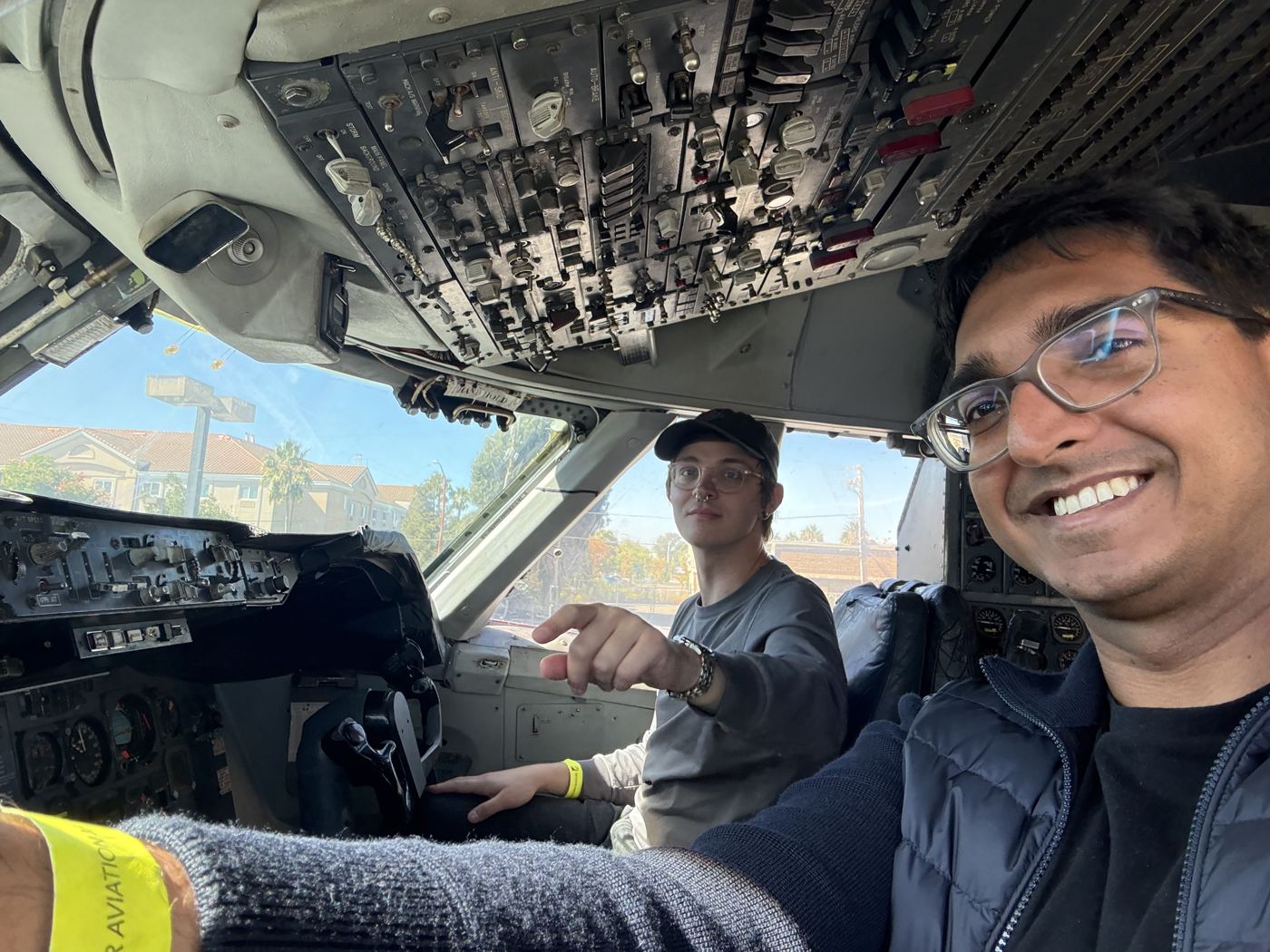 Grinning in a vintage airliner cockpit