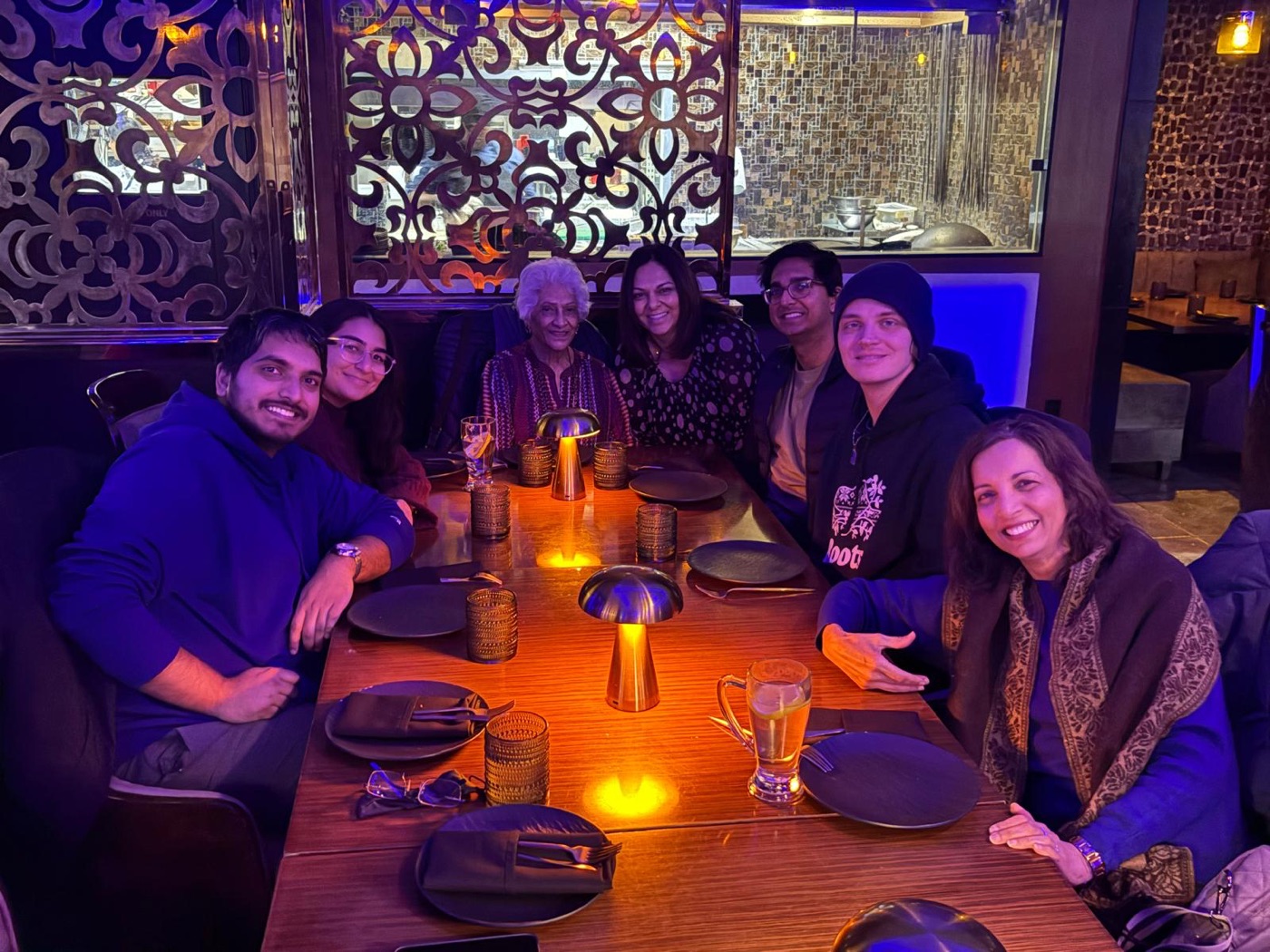 Family around a candlelit restaurant table