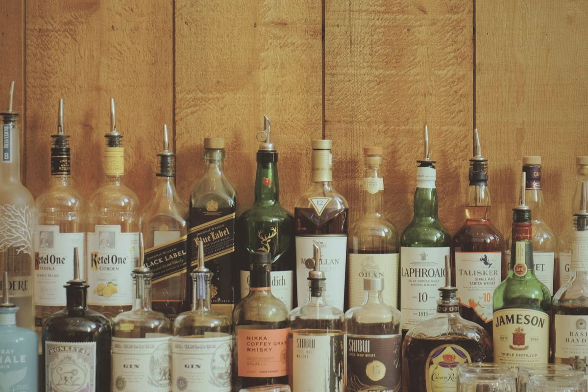 The Lodge bar's back wall of bottles against rough-sawn timber